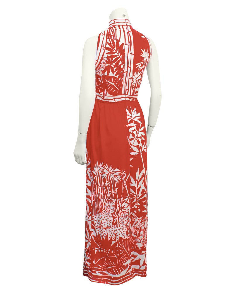 Red & white Paganne printed sleeveless, high neck maxi dress from the 1970's. Jungle print covers the entire dress with images of bamboo trees and cheetahs. Great maxi dress for the day with lace up sandals, or a beautiful statement evening gown,