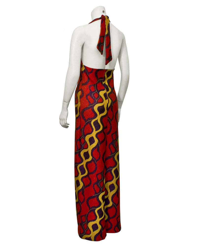 Streamlined red, gold and deep purple lurex knit halter gown from the 1970's. A very relaxed and timely look for Scaasi who catered to the elite of NY society. This is his nod to the more bohemian taste of the time. In excellent condition, fits like