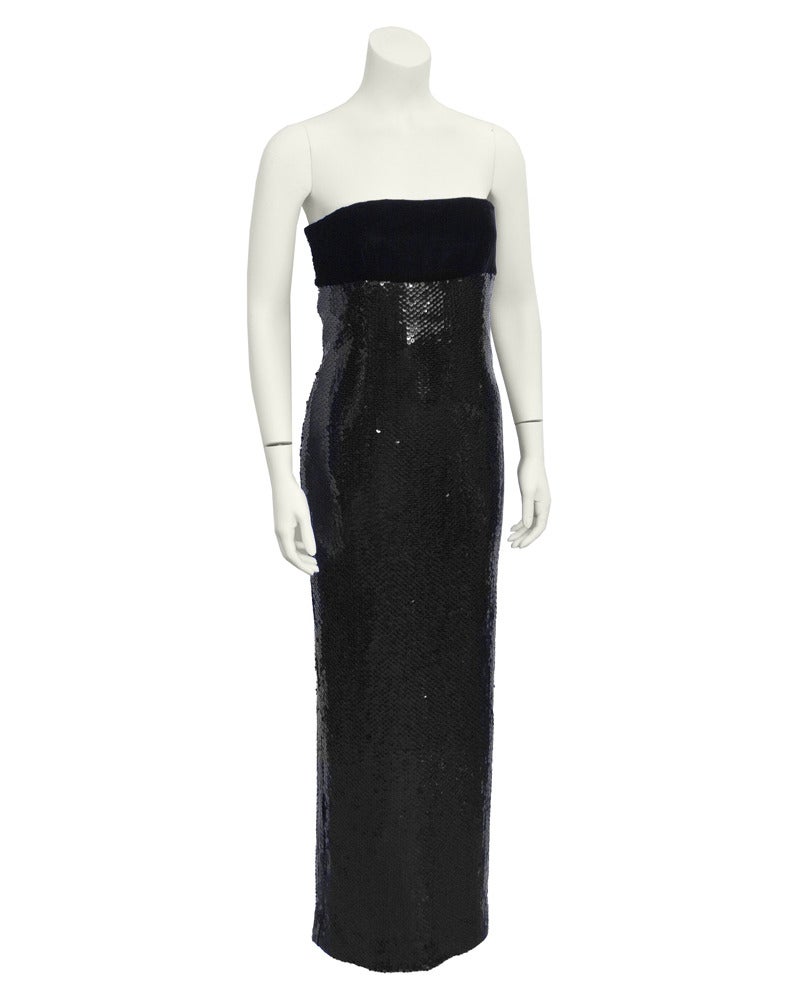 Beautiful strapless Bill Blass column gown from the 1980's. The dress has a jet black velvet bust area with darts. The top is complemented by the fish scale style sequinned bottom which starts right under the bust, like an empire waist. Very narrow