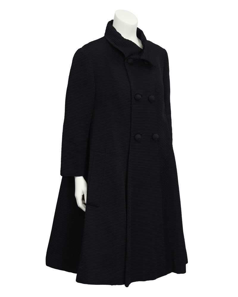 Darling 1960's Italian designed Simonetta double breasted black corded day/evening swing coat. Bracelet length sleeves, slanted side pockets, stunning spiral buttons and slightly exaggerated collar. Beautiful and classic shape, just as relevant