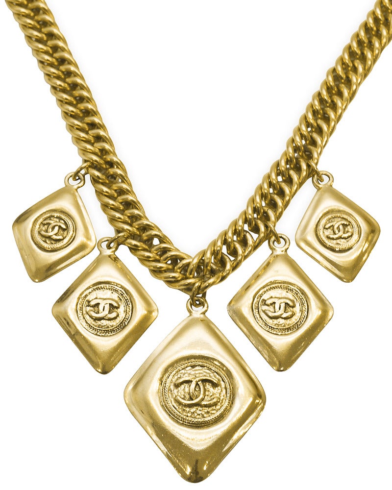 Chanel gold plated chain and medallion choker from the mid to late1980's. The graduated diamond shaped medallions vary in size; the largest at 2.25