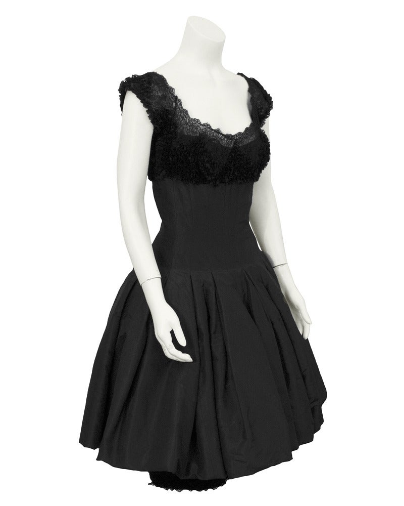 Black silk taffeta and scrunched lace cocktail dress with pouf skirt, cap sleeve and lace bodice finished off with a sexy pencil narrow underskirt. The look is sophisticated 1960's New York socialite. Excellent vintage condition. Narrow fit through