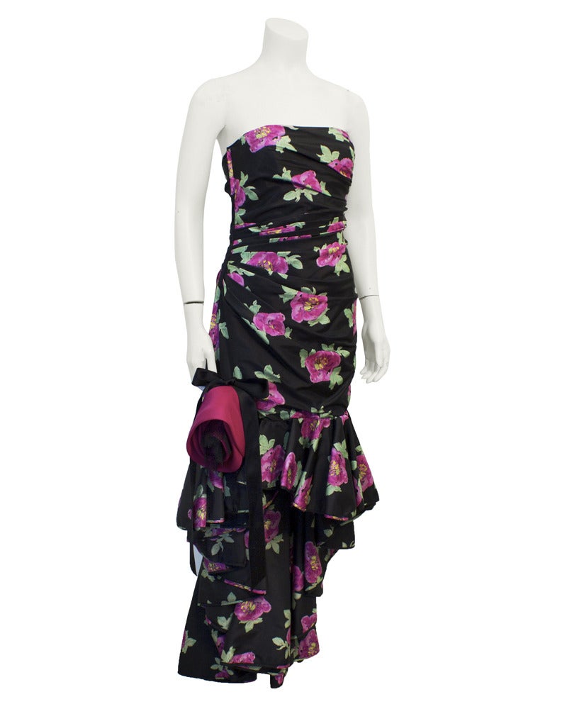 Divine Ungaro 1980's strapless gown with ascending layered flounce hemline and stunning cabbage rose, lace and ribbon add on. Ungaro was famous for figure flattering gathered and tucked bodice dresses. Vibrant magenta roses with green leaves on