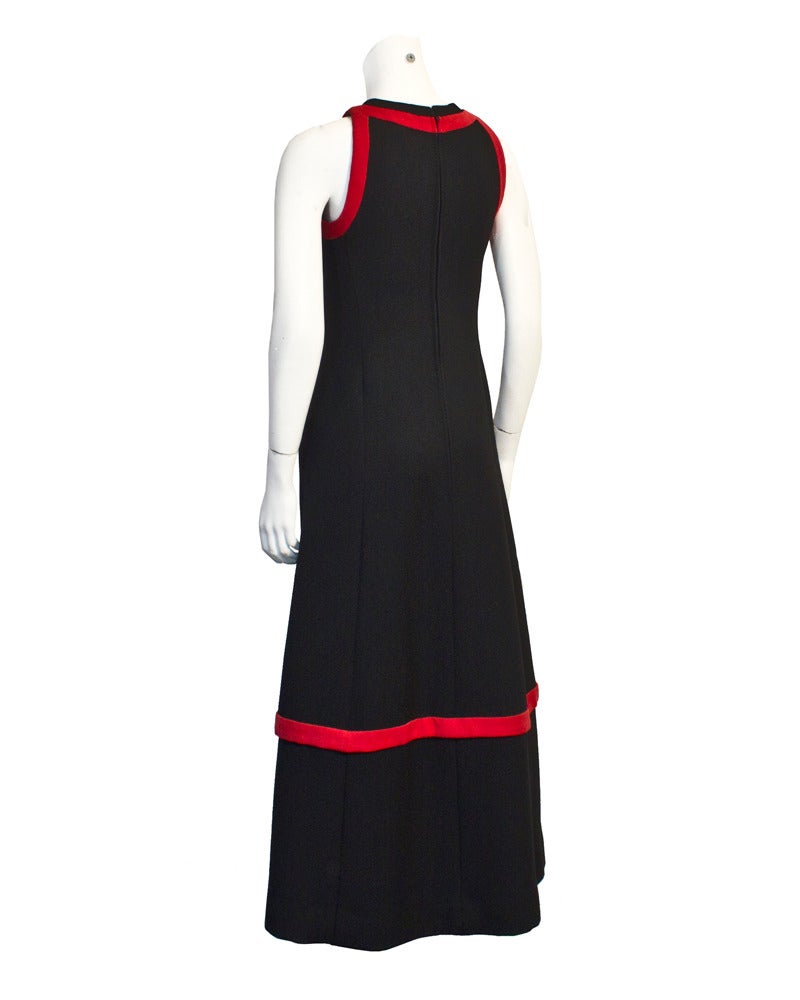 Mod black wool A-line gown from the 1960s with red wool trim and embellished neckline. All the design elements are inspired by Pierre Cardin's 1960's sleek modern vision. The weight of this dress alone lets you know it was built to last. Inset