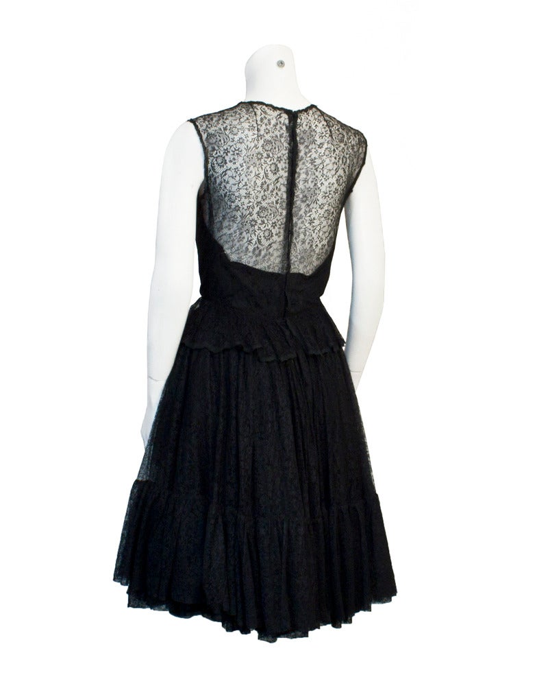 Early 1960's Holt Renfrew Canada couture design studio dress with fine black lace overlay and full layered skirt. Strapless silk under dress. Many layers of the softest lace are topped off with a saucy peplum detail at the waistline and an added