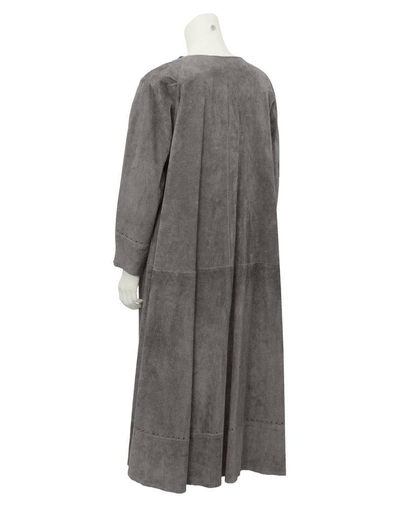 Open front 1970's duster style neutral grey suede coat with feminine tie-up and romantic open cut-work details. Generous fit with loose gathers. In excellent vintage condition.