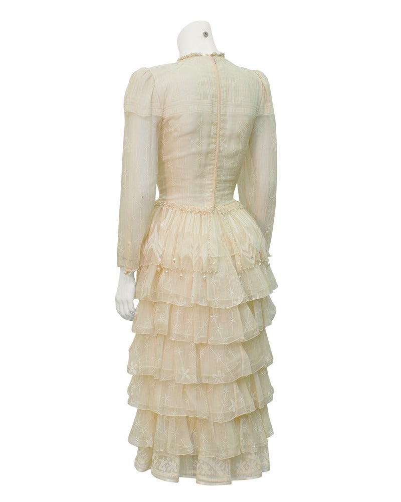 Subtle cream painted chiffon Zandra Rhodes late 1970's evening dress. Tiered skirt trimmed in pearls, hand sewn jeweled neckline, all signature details of a one of a kind couture piece. Worn once as a wedding gown. Carefully stored. In excellent