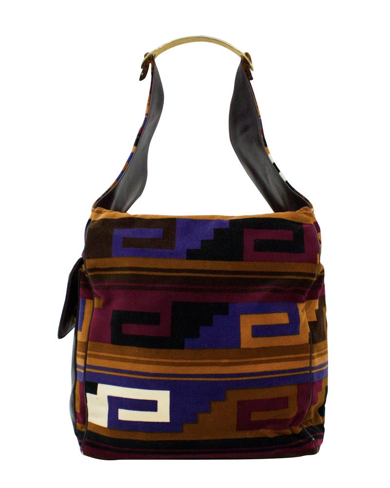 Unusual 1960's Roberta Di Camerino square velvet tote bag featuring an Aztec print of brown, maroon, purple, white and black. Deep brown leather lining and exterior large front flap pocket. Two flap closure at top. Gold tone metal handle attached