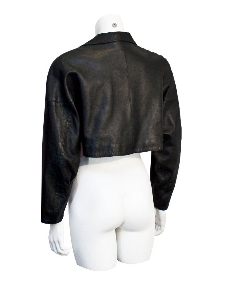 Edgy Alaia cropped jacket in black leather from the early 1980's. Alaia is best known for his body hugging dresses and this piece is the perfect accompaniment. The fit is slightly oversized and when worn over a bodycon dress it adds the perfect