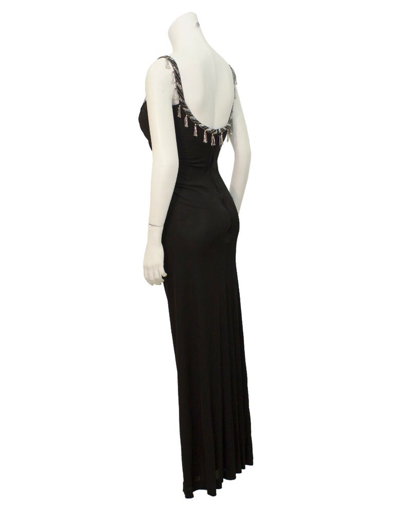 Sexy Bob Mackie 1980's gown with beaded straps. The low v neckline accentuates a woman's curves, a staple of Mackie gowns, and the beaded straps add elegance making this gown perfect for a black tie event. In excellent vintage condition. Built in