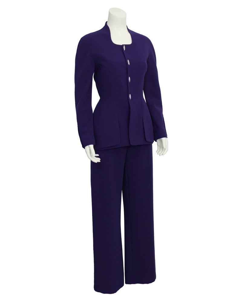 Early 1980's Mugler deep purple gabardine pant suit with modernist silver buttons on cuffs and front. Waist accenting jacket with scoop neckline can be worn with or without a crisp white shirt. In excellent vintage condition. A collectors