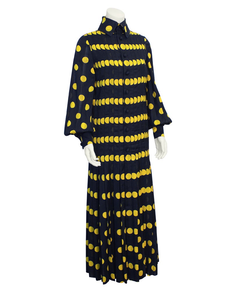 Navy and yellow polka dot jacquard 1970's Jean Patou gown with button front and pin tucked pleating. Very OP-ART in its bold expressive pattern. Wide button cuff and full sleeve are typical of the era. In excellent vintage condition, worn once.