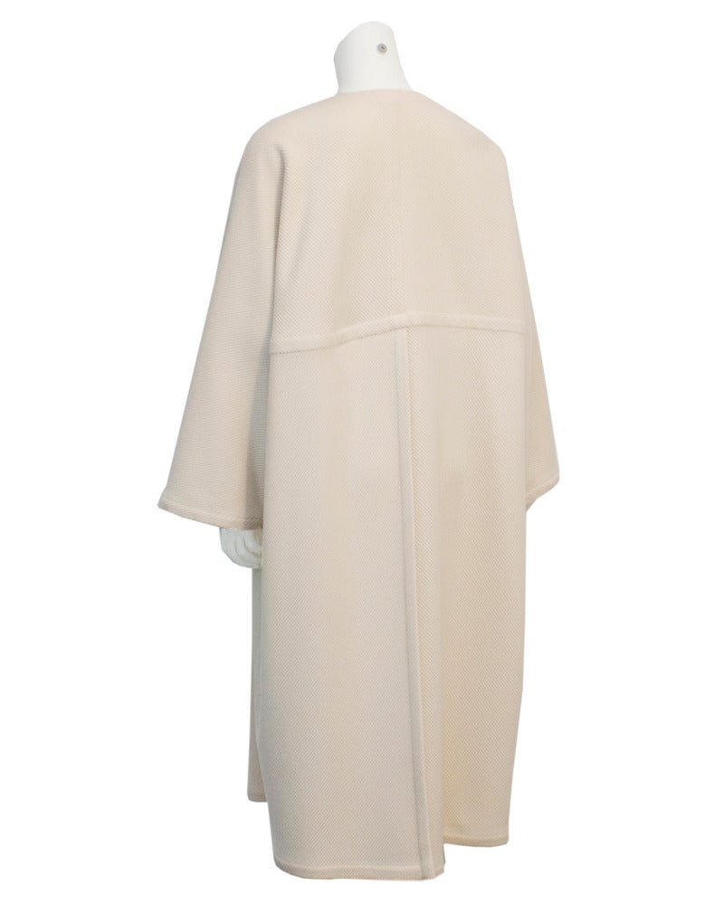 Krizia cream wool coat with heavy detailed seams, open concept front, drop shoulder and tons of style! Circa 1980's label purchased from Creeds Toronto, the boutique to the carriage trade from 1950's until it closed in the late 1980's. Highest