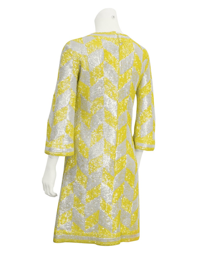 Fabulous Mod 1960's 3/4 length bell sleeve knit dress with yellow and white sequin and beaded chevron pattern. Neckline, cuffs and hem are trimmed in  yellow and white sequin and beaded stripe. Shape and pattern of the dress has the essence of the