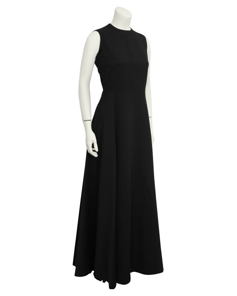 Simple and stunning beautiful Geoffrey Beene 1960s gown. Sleeveless with curved seams at the waist that create a full skirt that with beautiful draping. Invisible zipper up the back and wide hem that can be easily dropped by a dress maker for a