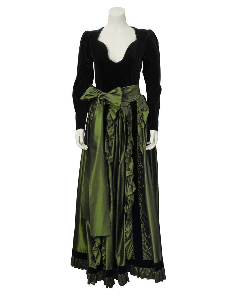 Saint Laurent Rive Gauche top and skirt ensemble dating from the 1980s. Top is jet black velvet with long sleeves and an interesting V neckline. The floor length full skirt is a deep evergreen silk taffeta with vertical ruffled and black velvet