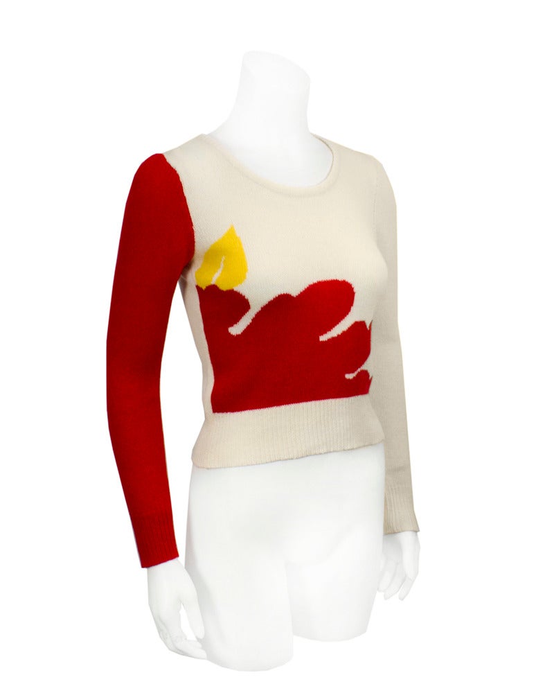 Early 1980's Krizia vintage wool sweater with Pop-Art style image of candle. Almost a cropped fit, very baby-tee in its Mod look. Old graphic image in red cream and yellow. A statement piece typical of 1980's Krizia knits. Favored by Princess Diana,