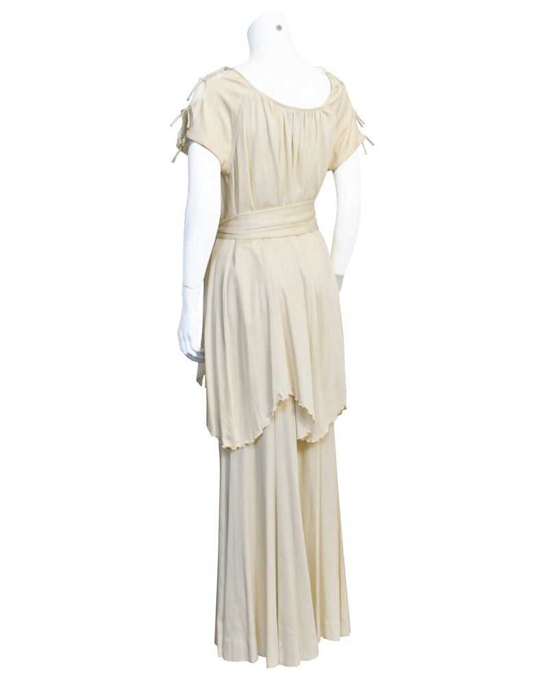 This comfortable yet chic cream jersey ensemble from the 1970s by Giorgio di Sant'Angelo, who was best known for his gypsy-esque jersey pieces, is the perfect look for a casually elegant evening. The long palazzo style pants have an elasticized