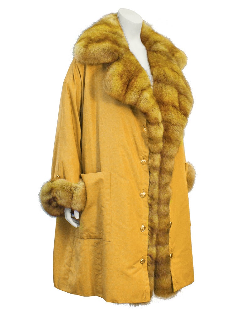 1980's Christian Dior Haute Fourrure luscious golden colored sable trimmed coat. Styled with gold button details almost as if the outer coat can be removed. Coat becomes satin trimmed evening coat for special occasions. In excellent condition. No