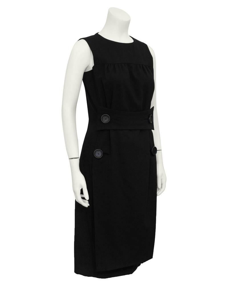 1960s Galanos black cocktail dress with a half front belt and four large leather covered buttons. Simply elegant, flawless design, timeless. Perfect day dress with boots or cocktail dress with diamonds and pumps. Excellent vintage condition.