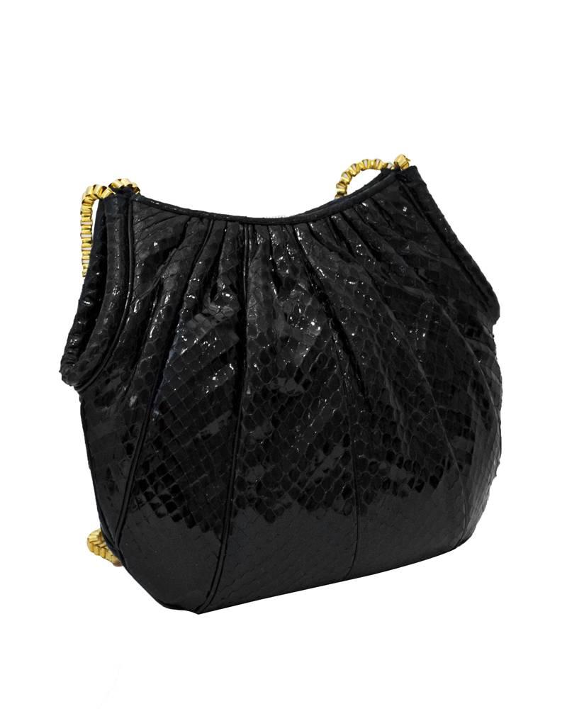 1980's Judith Leiber cross body black lizard skin bag with gold hardware. Double gold tone long chain link straps. Comes with original black and gold coin purse and gold comb with a large tassel. Good for day to evening user. Excellent vintage