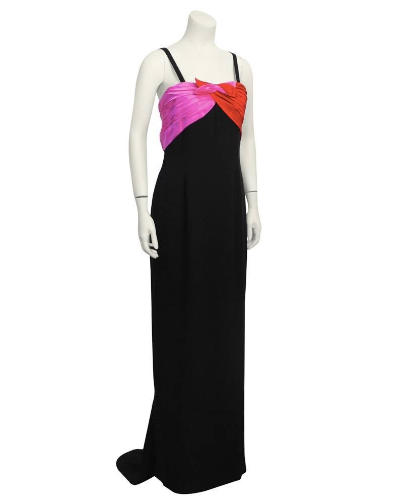 1970's beautiful Bill Blass black silk column style gown with spaghetti straps. Red and hot pink satin pleated wrap detail at bust twists and joins in centrer creating and abstract bow. Straps narrow to a razor back effect. Small and very elegant