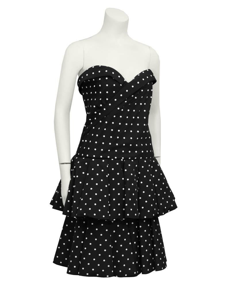 1980's black and white polka dot strapless CD de Christian Dior. Sweetheart neckline, drop waist with flouncy double layer skirt. Would look great with a black leather jacket. Excellent vintage condition.