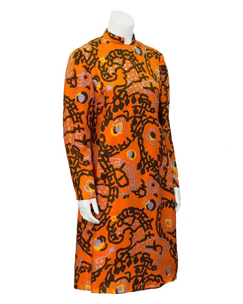 Quintessential 1960's Geoffrey Beene orange silk geometric long sleeve dress. This is an early Beene piece, as he was designing for Teal Traina until 1963, when he launched his collection. Dress has an abstract print throughout the silk in robins