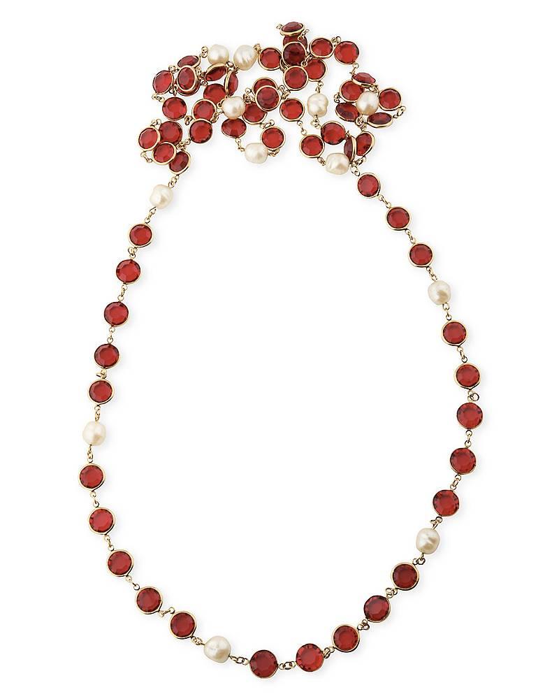 Beautiful and highly collectable long Chanel sautoir dating from 1981. No clasp, goes over the head and can be worn long or layered. Red cut crystal and faux pearls in a gold tone metal setting. Small circular gold Chanel tag with markings.
