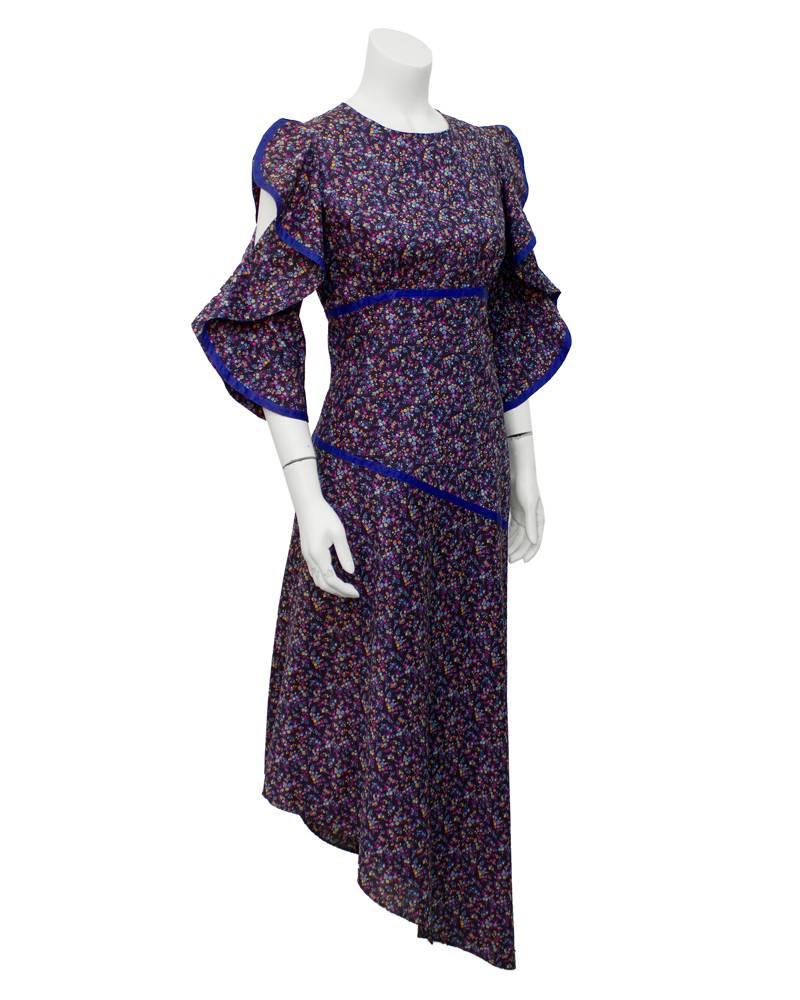 Cute as a button Liberty cotton Annacat dress with blue, purple, yellow and orange flowers and an indigo blue trim. From London's Annacat boutique, dating from the late 1960's. The cascading ruffle 3/4 sleeves attaches at the elbow, allowing the