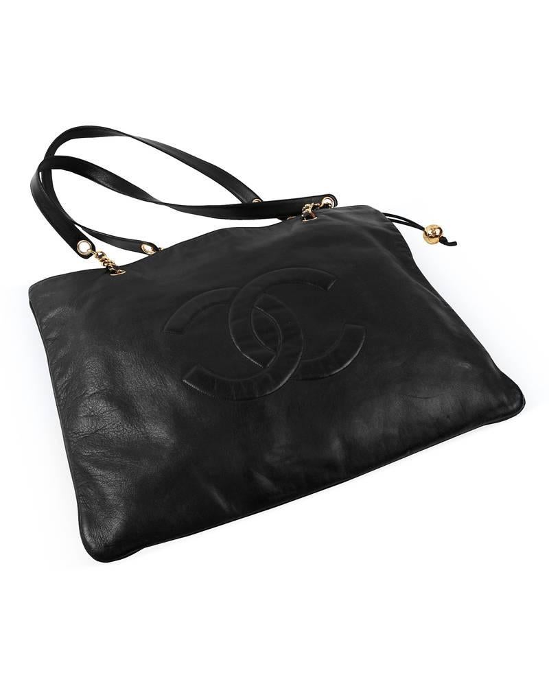 Great black kid leather flat tote bag. Stitched large CC logo in the center of the bag. Gold hardware details with Chanel markings. Excellent vintage condition, clean interior. Great for everyday use, fits laptop, work-out clothing, toddler extras.