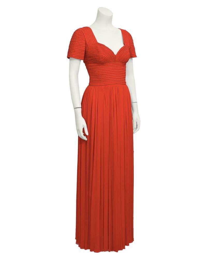 Early 1980's Oscar de la Renta red cap-sleeved gown, softly pleated skirt. Corded bodice and knit jersey skirt with chiffon under skirt. Corded effect perhaps Inspired by Valentino from the same era. Sweetheart neckline. Size 4. Excellent vintage