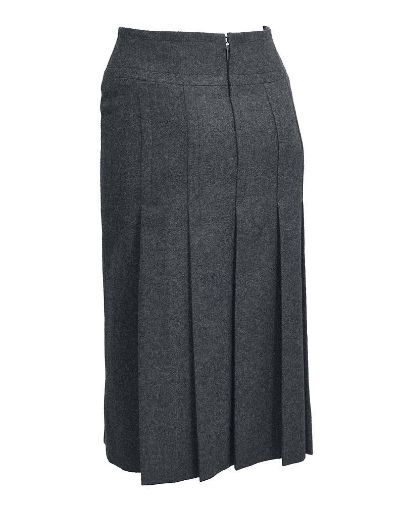 1970's Celine charcoal grey wool mid-length pleated skirt. Black leather detail at waist with gold tone metal horse-bit, detailed with Celine markings. Excellent vintage condition. Great for the colder months with black tights and boots. 