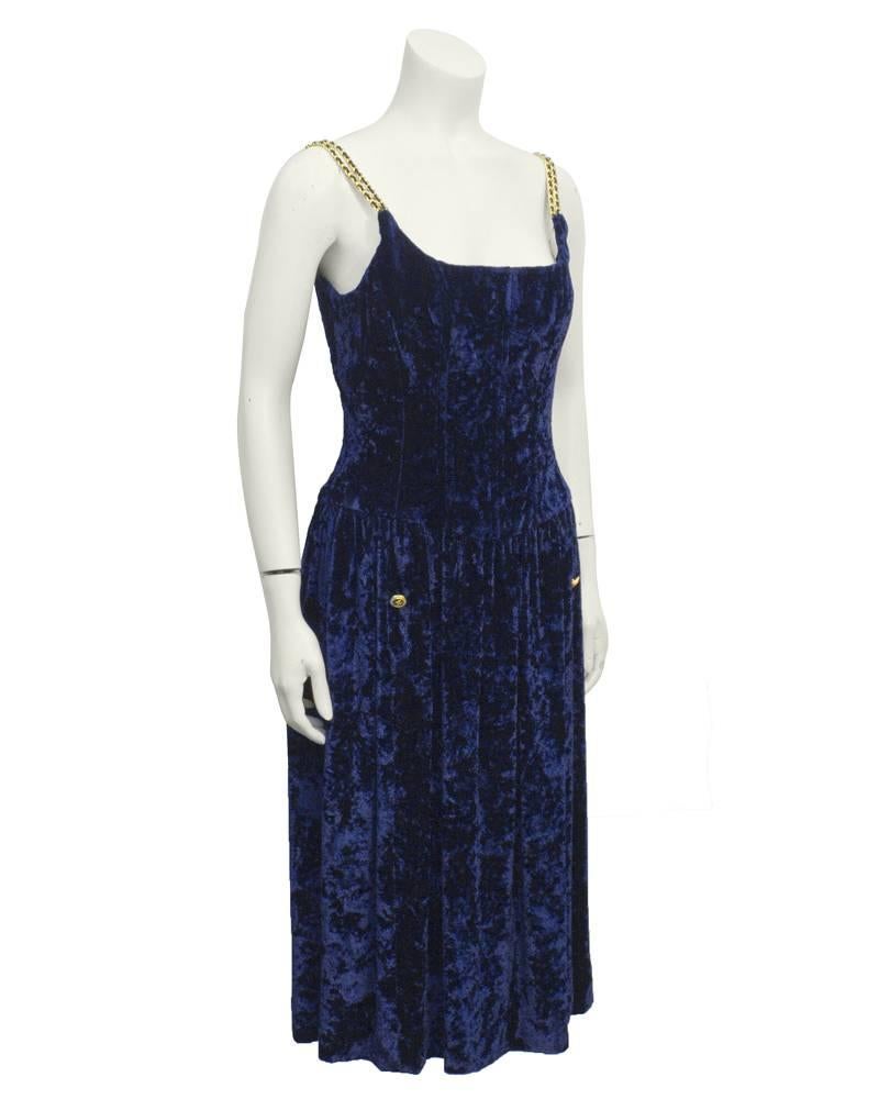 Chanel navy panne velvet dress with corset bodice. This dates from the early 90's collections and is highly treasured for its fit and the Chanel chain details. Good gold and navy buttons, fully lined in silk. Excellent vintage condition.  Fits like