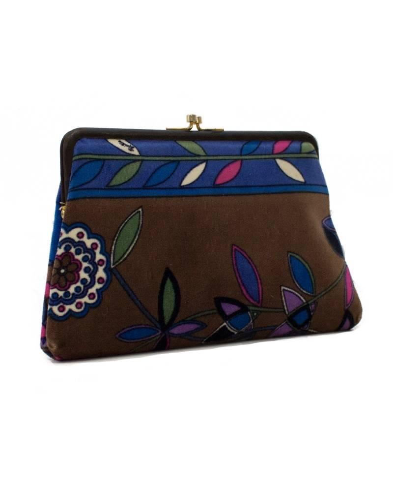 Emilio Pucci velvet clutch from the 1960's. The signature floral pattern in colors brown and royal blue, with notes of pink, black, white, purple, and green. Black leather trim on top, with a gold tone kiss lock clasp. Interior is lined in olive
