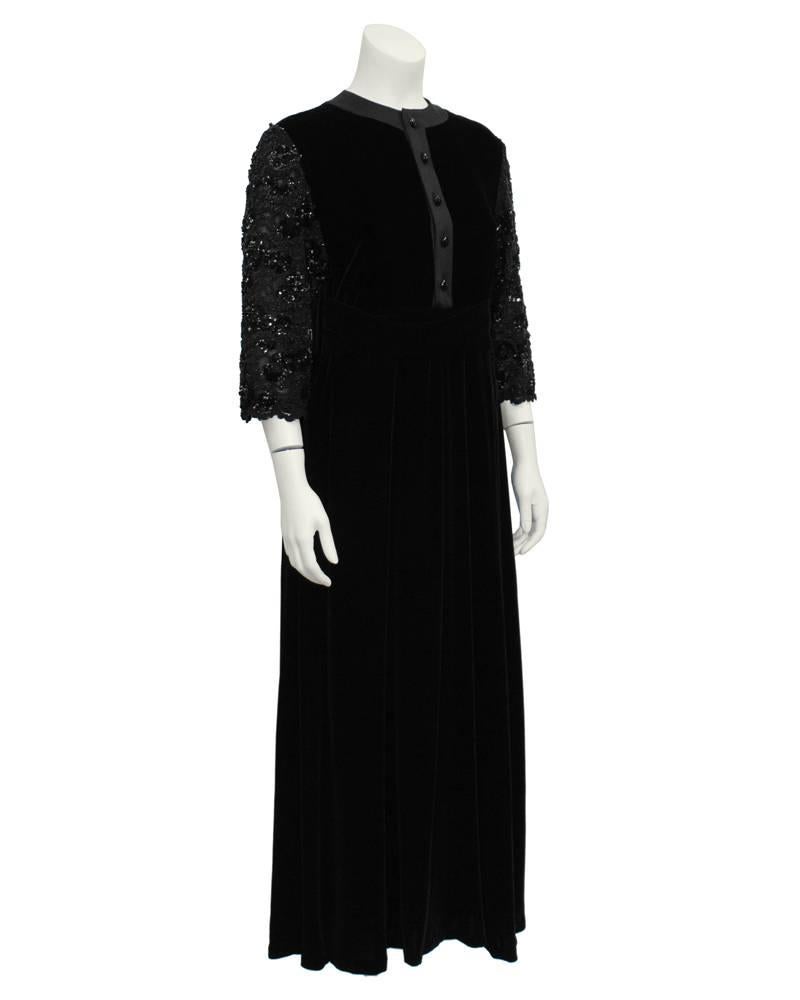 Classic black velvet Jean-Louis Scherrer couture dress with beaded 3/4 sleeves from the 1980's. High neckline with black buttons down center. Gorgeous multi stone jet beading with sequin details cover the three-quarter length sleeves. Black velvet