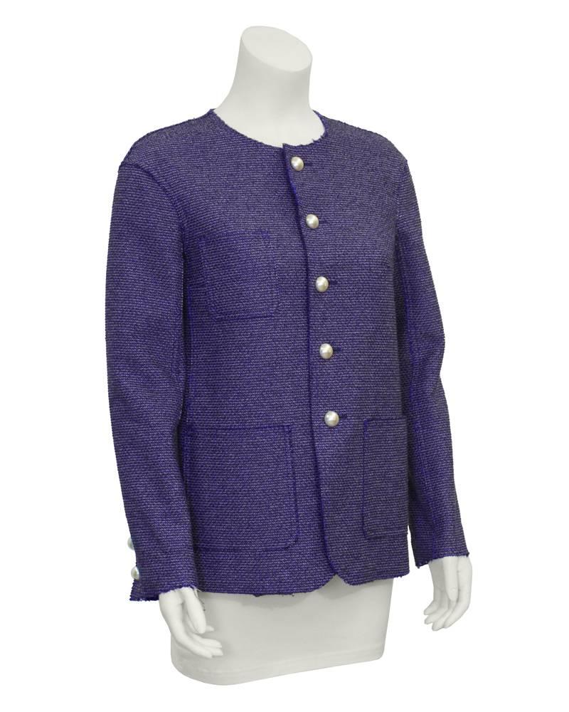 Chanel Purple Tweed Jacket from the Spring/Summer 2013 collection. This collarless jacket features three front pockets, a button closure, and three charming buttons on each sleeve cuff. Buttons are pearl with small CC logo on them. A modern twist on