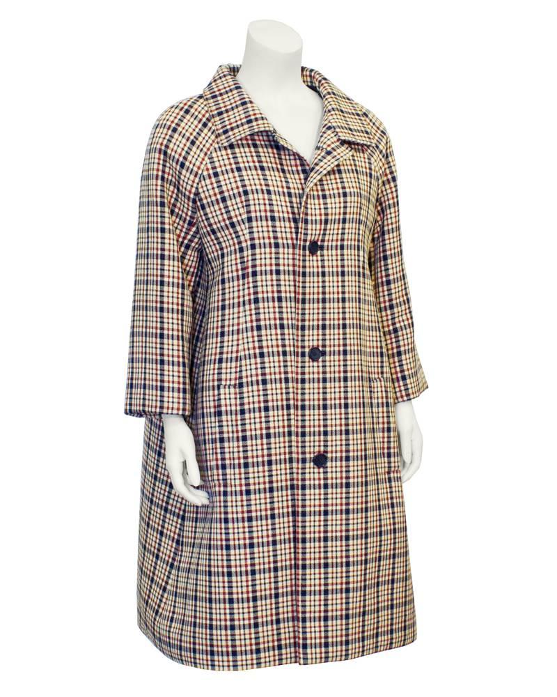 Gorgeous Givenchy coat from the 1960s. Structured A-line shape with red, white and navy blue plaid. Wide collar, with three navy blue buttons. Slit pockets on side. Excellent vintage condition.