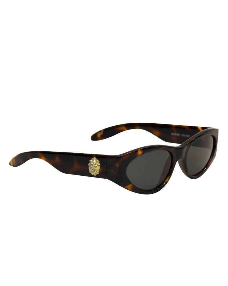 Versace faux tortoise glasses for their VERSUS line. Designed in the 1980's with the classic Versace lions head medallions featured on the oversized side arms. In excellent condition.Excellent vintage condition.