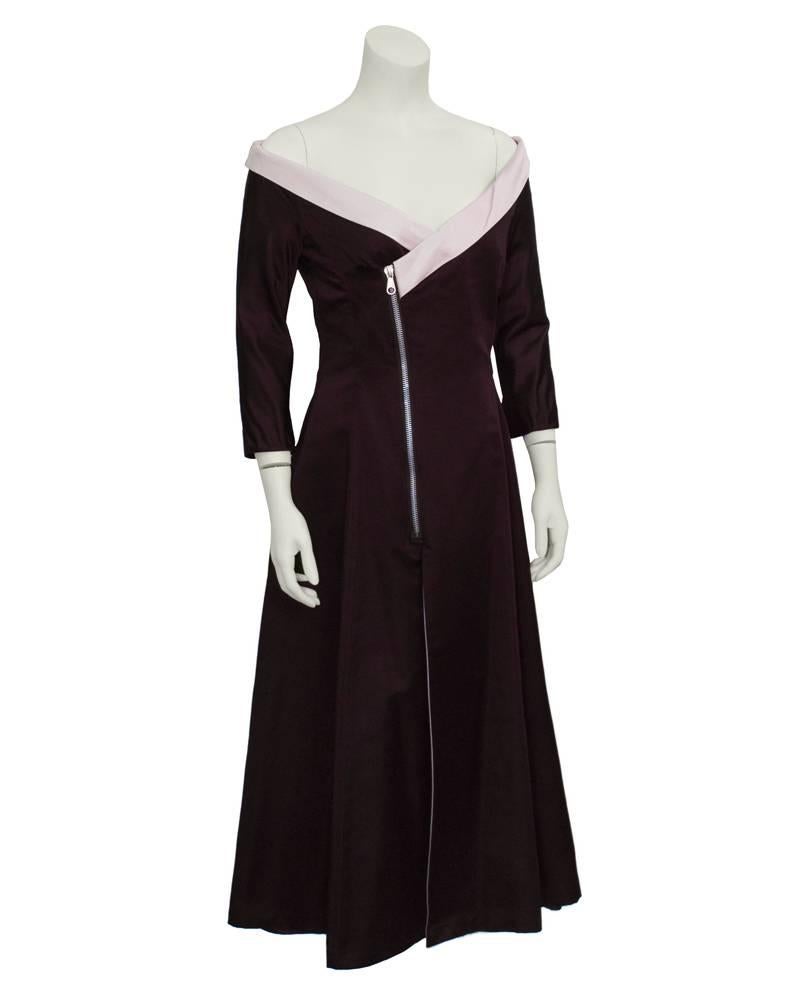 Interesting Stella McCartney for Chloe silk dress from the 1999-2000 collection in stunning plum satin finished with a pink off-the shoulder neckline. Asymmetrically cut, with a dramatic metal diagonal zip closure on front. Skirt is flared with a