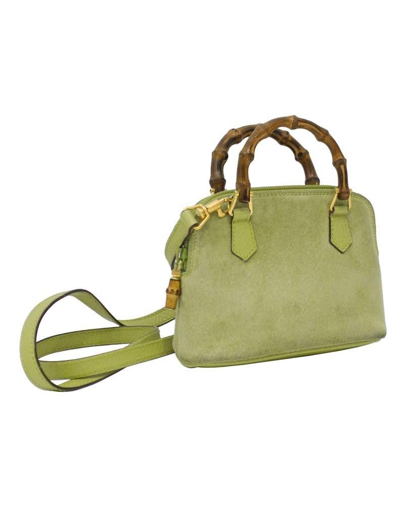 Adorable Gucci light green suede mini-bag with iconic bamboo handle from the 1980's. Features gold tone hardware and green leather tabs. Comes with a long green cross body leather strap. Zip closure with a bamboo detail on the pull tab. Interior is