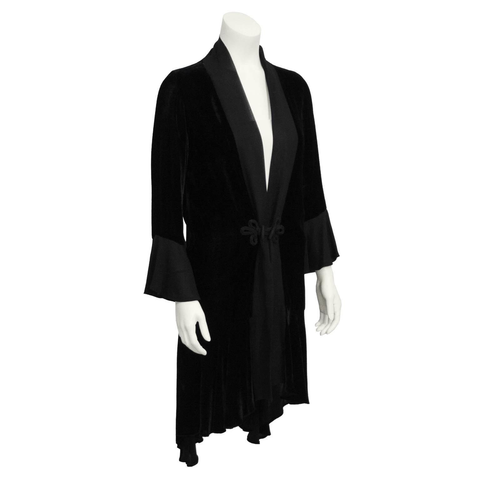 Elegant black velvet robe jacket from the 1930's. Jacket, typically worn over a beaded chemise is silk velvet with a chiffon trim and green silk lining. Chiffon sleeve flares at wrist. Hemline is trimmed with chiffon flowing from a high front to a