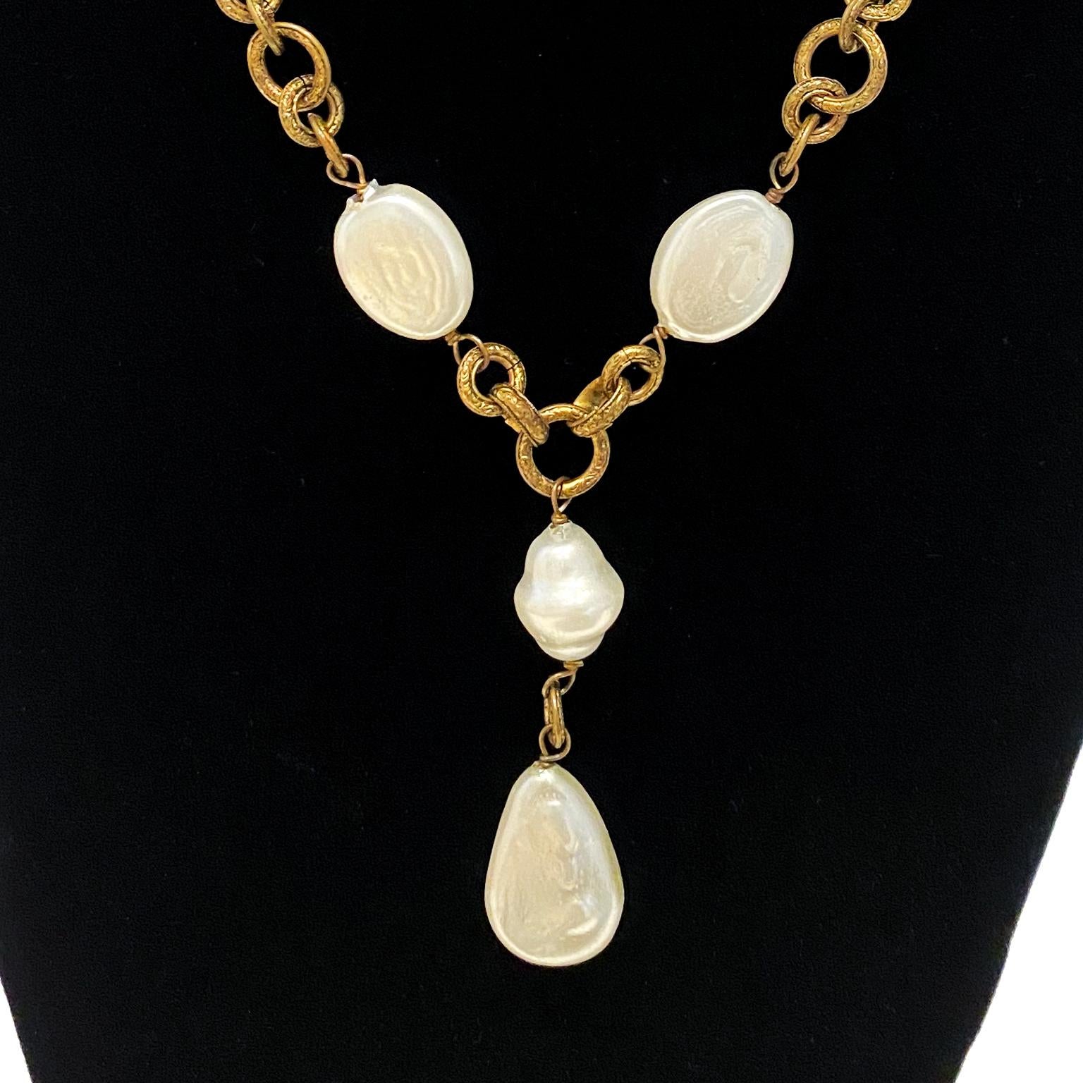 Chanel 1985 natural shape flat pearl and gilt metal chain necklace with pearl drop. Beautiful patina to the the engraved triple link chain. Pearls are in excellent condition with no signs of damage or unusual wear. Chanel 1985 date plaque mounted on