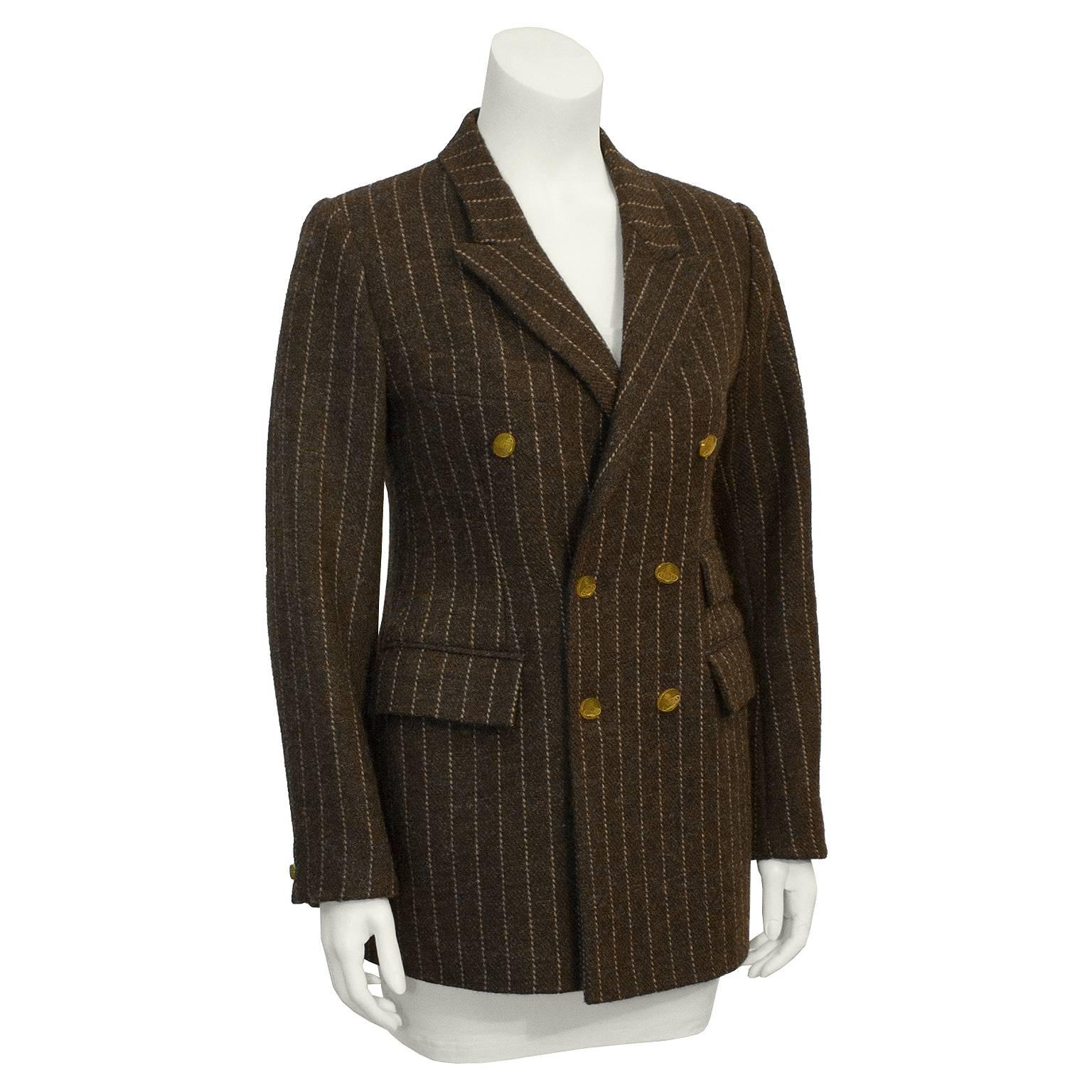 British punk designer Vivienne Westwood's wool blazer from the 1980's. Heavy weight brown wool, with beige pinstripes. Two flap pockets on right waist, one on the left waist and a slash breast pocket on the left. Double breasted, with mustard