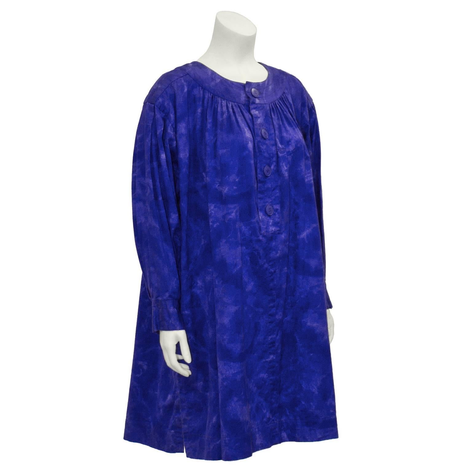 Both comfortable and chic, this Yves Saint Laurent smock dress dates from the early to mid 1980's. The loose-fitting cotton dress is in a bold indigo color that's dip dyed throughout. High scoop neck, with indigo buttons down the front placket. Long