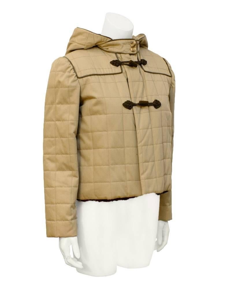 Valentino sheared fur lined quilted mini duffle style jacket in beige poplin. Feminine gathered shoulder.... not over wide, pointed attached hood, brown toggles and trim. Adorable. Excellent condition from the 1980's. Cozy and cute. Size US 6