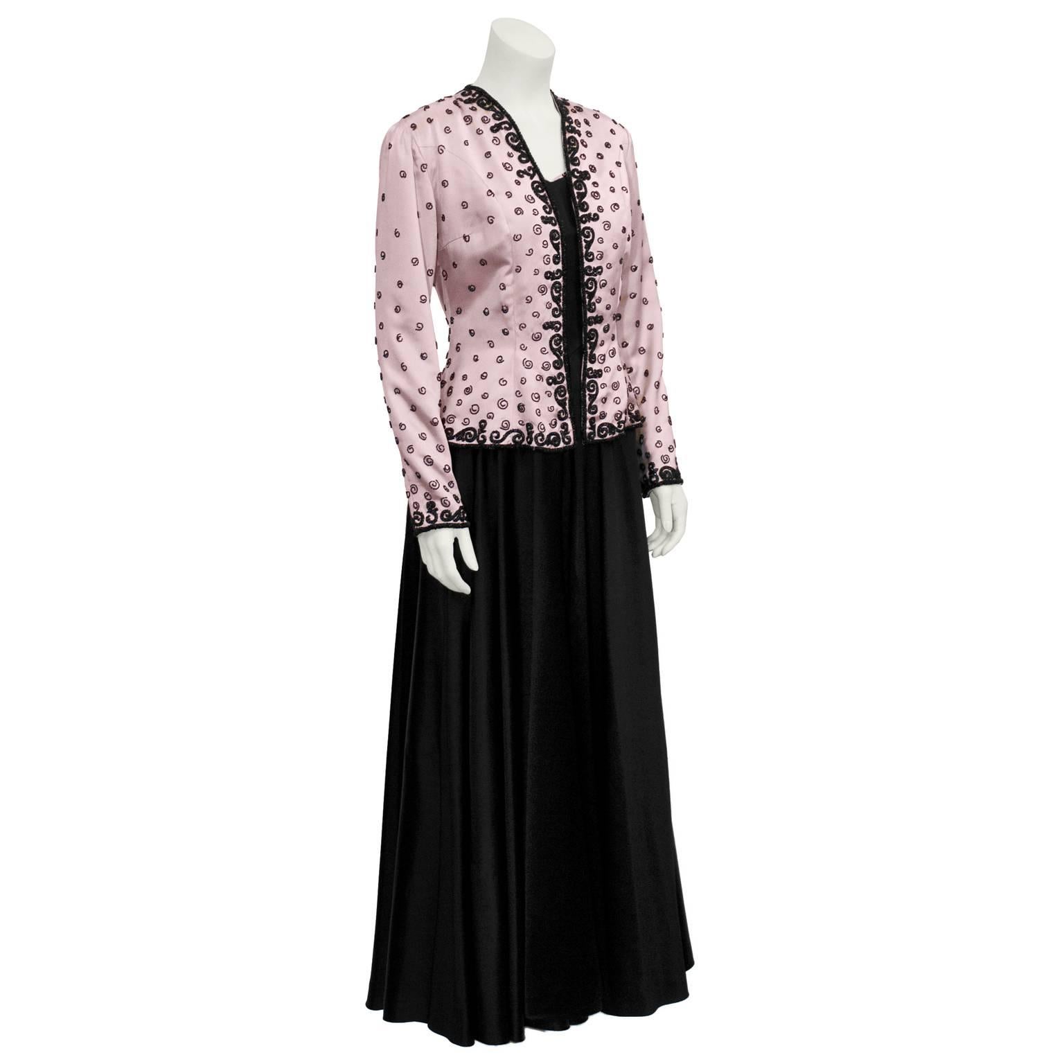 Amazing black satin gown with a matching pink satin jacket attributed to Schiaparelli from the 1940's. Purchased and worn in Toronto by an elegant socialite for her daughters wedding, it is believed to have been purchased at the T Eaton Company. 