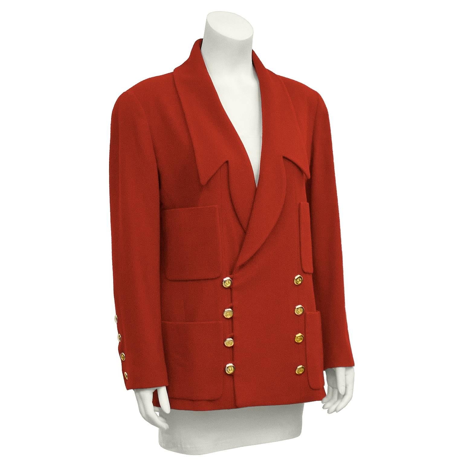 Amazing Chanel red cashmere blazer from the 1980s. Features uniquely cut lapels, two vertically aligned patch pockets on each side. Double breasted, with gold buttons embossed with CC logo on them. Four buttons on each sleeve. Excellent vintage
