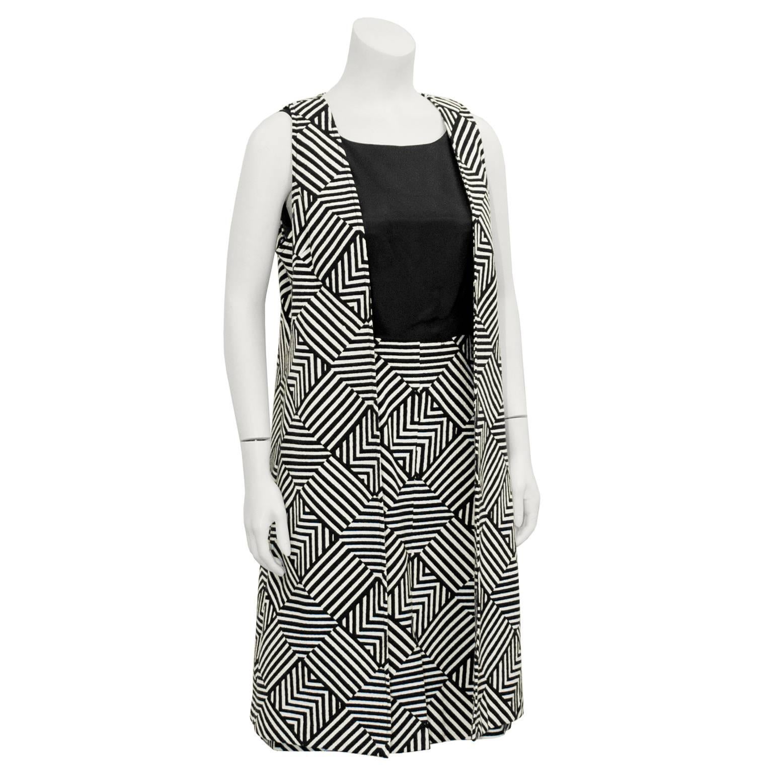 Eye-catching Mod geometric striped black and white dress and maxi vest from the 1960's. Simple sleeveless sheath dress with a squared neckline, black bodice, fitted waist, and bold softly quilted geometric pattern skirt. Vest is patterned all-over