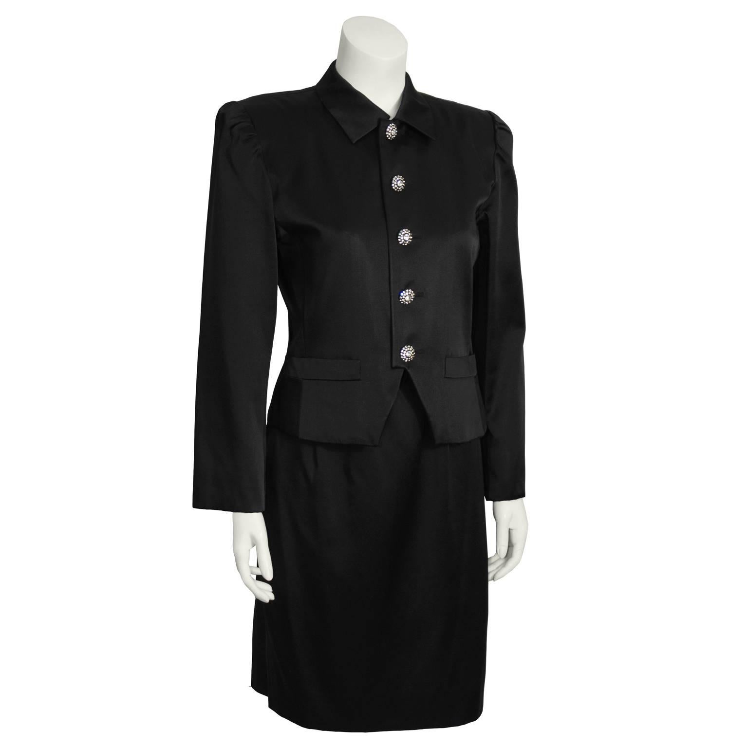 Gorgeous Yves Saint Laurent satin skirt suit from the 1980's. Jacket has slightly puffed shoulders with medium shoulder pads, nicely fitted through the waist. Two flap pockets at hips. Front button closure with eye-catching rhinestone buttons.